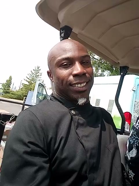 Chef Whittaker smiling in a black chef coat